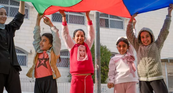 Children playing with a parachute.