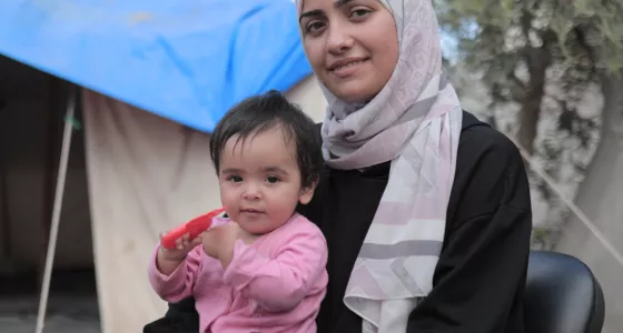 A woman with a child sitting on her lap.