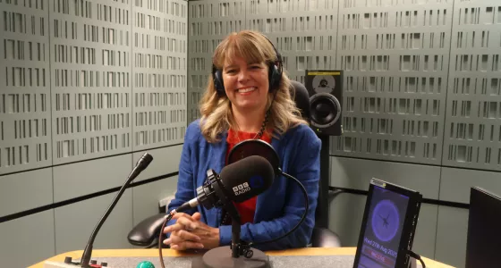 Claudia Hammond sits smiling in a recording studio