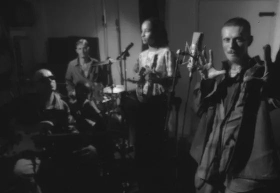 Behind the scenes black and white photo of the recording of HELP! featuring various artists.