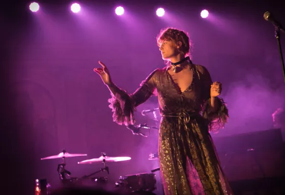 Florence and The Machine looks ethereal whilst performing on stage drenched in purple lighting for BRITs Week 2016.