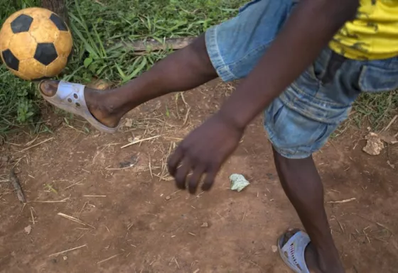 Frederique, a former child soldier, playing football next to War Child's friendly space.