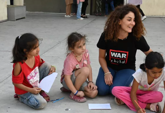 War Child staff member with children in a safe space. 