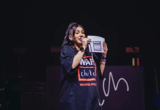 Ellie Prohan on stage speaking at a BRITs Week show in 2024. 