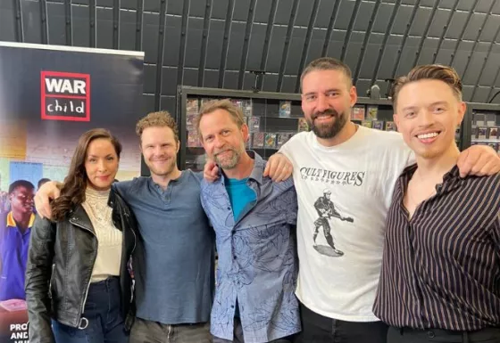 A group of people standing together and smiling.