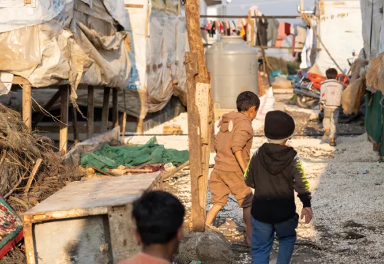 Children walking through a refugee camp in Syria. 
