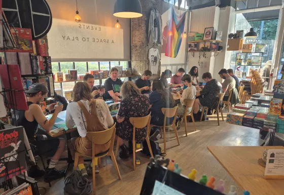 People sitting at a table playing Magic the Gathering