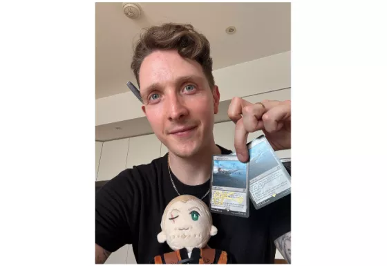 Christopher holding the signed cards