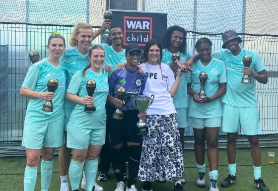 The winning team standing with their trophies.