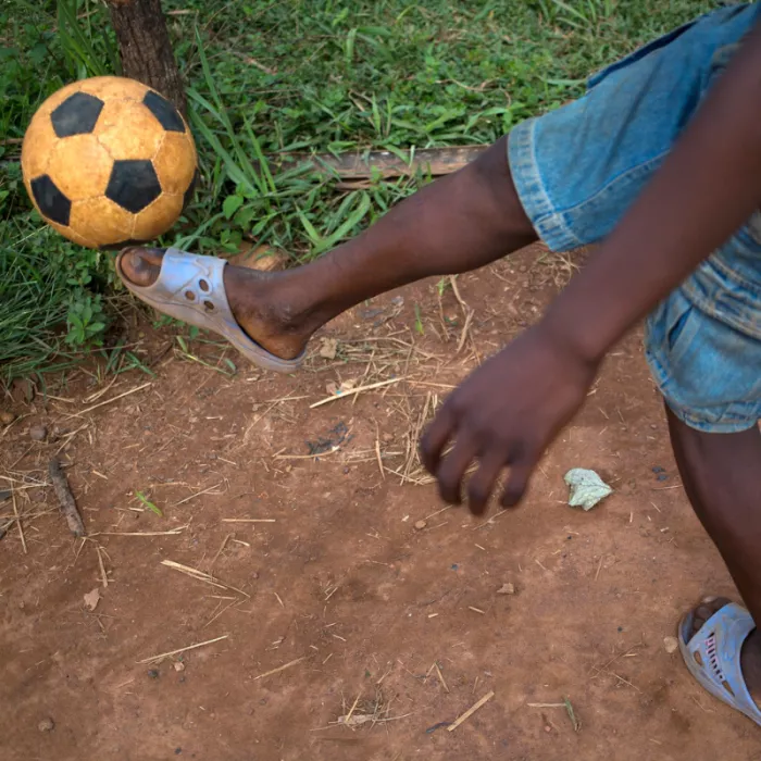Former child soldier, Frederique playing football in the Central African Republic.