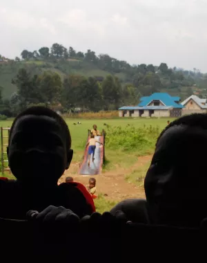 Children in the Democratic Republic of Congo peer through a school window.