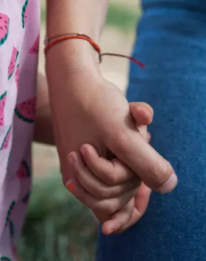 War Child staff member holds participants hand.