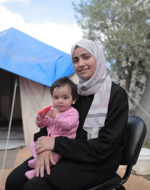 A woman with a child sitting on her lap.
